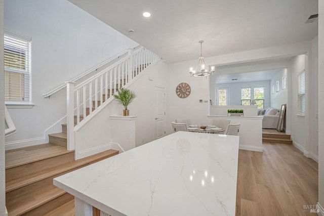 dining area featuring visible vents, a notable chandelier, stairway, recessed lighting, and light wood-style flooring