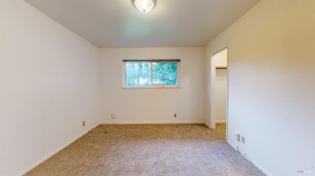 unfurnished bedroom featuring carpet floors and baseboards