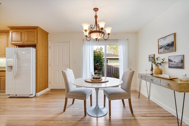 1811 Pacifica Ct, Benicia, CA 94510 - dining room featuring light wood-type flooring, an inviting chandelier, and baseboards