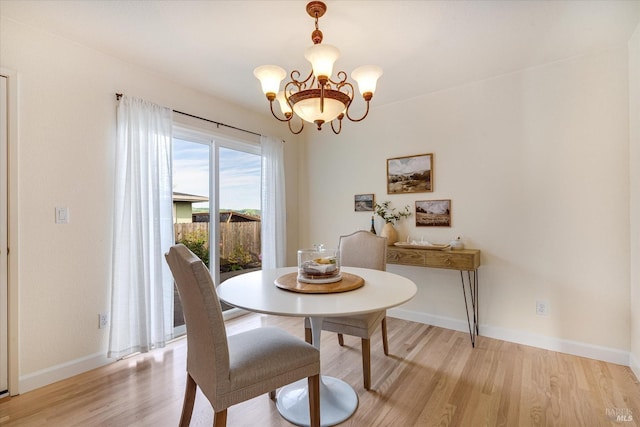 1811 Pacifica Ct, Benicia, CA 94510 - dining room with light wood-style floors, a notable chandelier, and baseboards