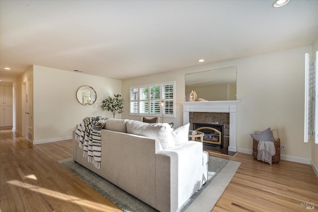 1811 Pacifica Ct, Benicia, CA 94510 - living room with recessed lighting, a tile fireplace, light wood-style flooring, and baseboards