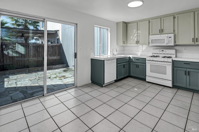 kitchen featuring gray cabinets, light countertops, and white appliances
