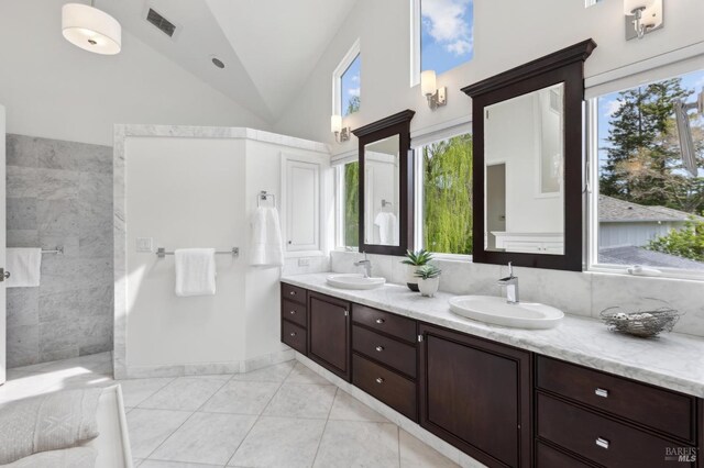 full bathroom with tile patterned floors, walk in shower, a sink, and double vanity