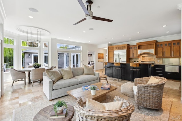living room with recessed lighting, stone tile floors, crown molding, and ceiling fan