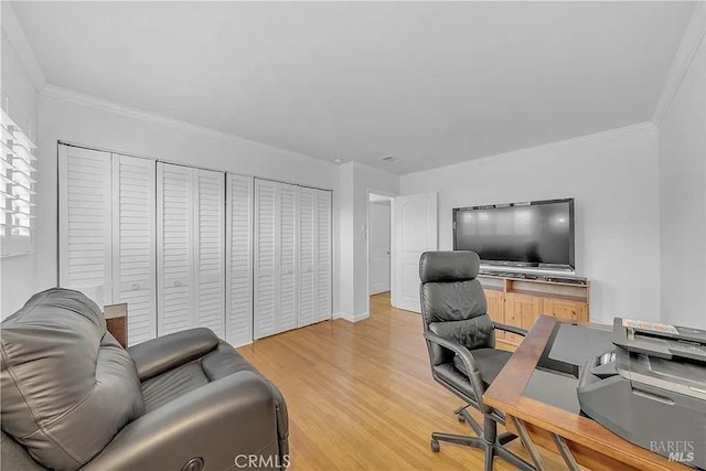 home office with light wood finished floors and crown molding
