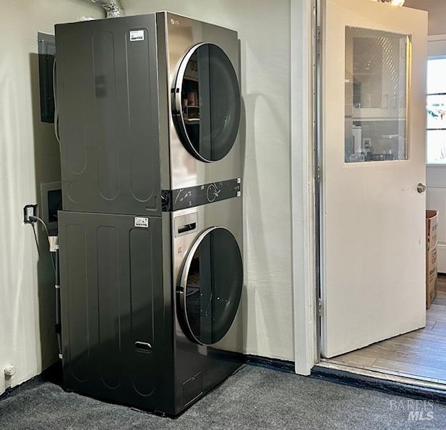 laundry room featuring stacked washer and dryer and laundry area