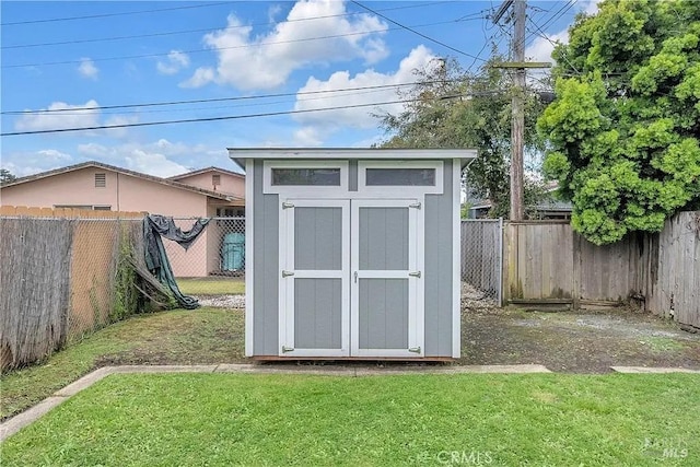 view of shed with a fenced backyard
