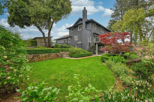 exterior space featuring a lawn and a chimney