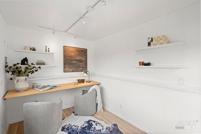294 Scenic Rd, Fairfax, CA 94930 - home office with rail lighting, wood finished floors, built in study area, and baseboards