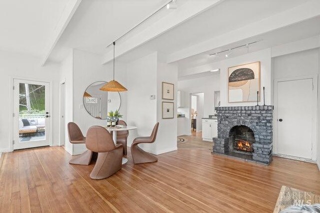 294 Scenic Rd, Fairfax, CA 94930 - dining room featuring track lighting, light wood-style floors, and a stone fireplace