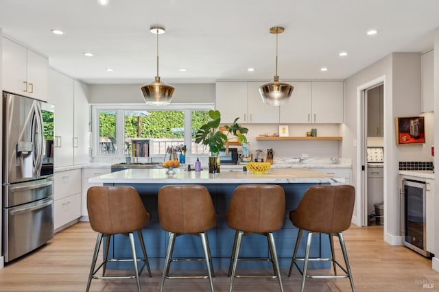 299 Via Barranca, Greenbrae, CA 94904 - kitchen with light wood finished floors, stainless steel fridge with ice dispenser, light countertops, and beverage cooler