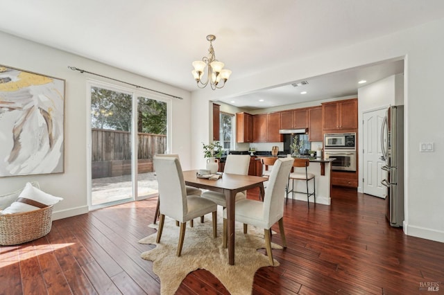 dining area featuring a chandelier, dark wood-style flooring, baseboards, and visible vents