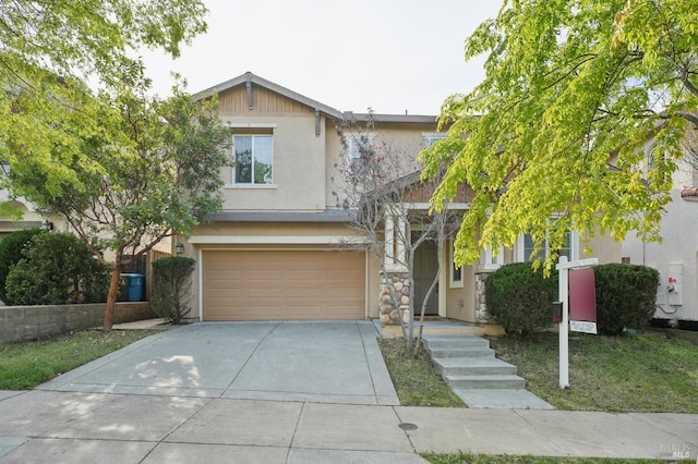 view of front of property featuring driveway, a garage, and stucco siding