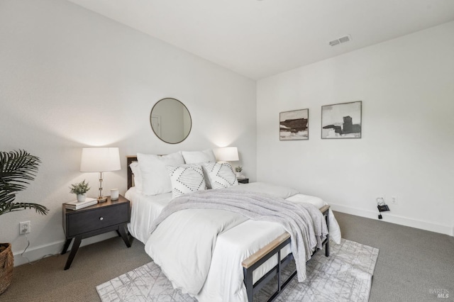 bedroom with visible vents, light colored carpet, and baseboards