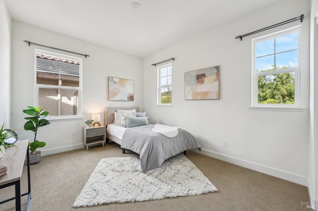 carpeted bedroom featuring baseboards