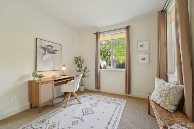 office area featuring light colored carpet and baseboards