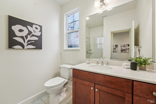 bathroom with vanity, baseboards, a stall shower, toilet, and visible vents