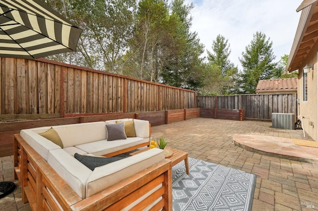 view of patio / terrace featuring central AC, a fenced backyard, and an outdoor hangout area