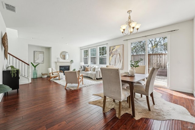 dining room with visible vents, plenty of natural light, an inviting chandelier, and stairs