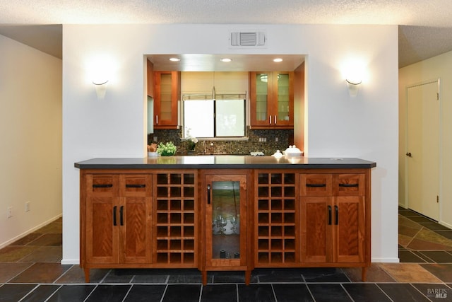 bar featuring tasteful backsplash and visible vents