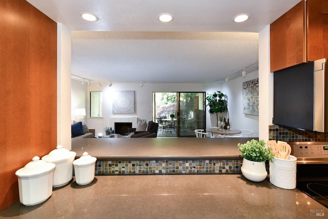 interior space featuring recessed lighting, a fireplace, and track lighting
