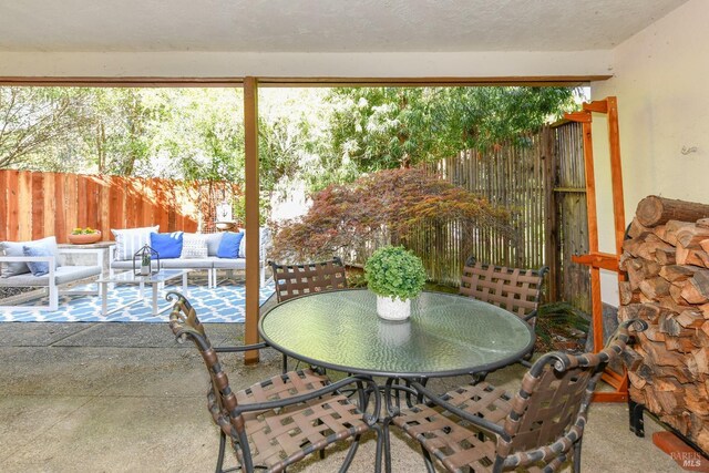 exterior space with outdoor dining space, a fenced backyard, and an outdoor hangout area