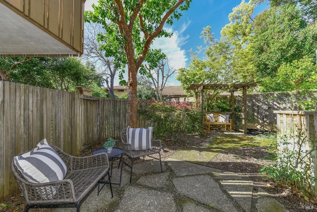 view of patio / terrace with a fenced backyard and a pergola