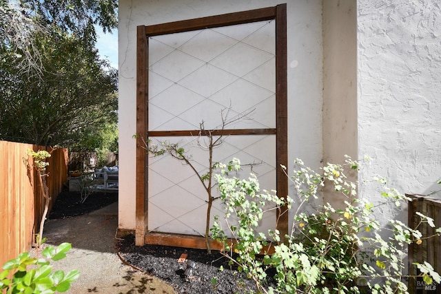 view of outbuilding featuring fence