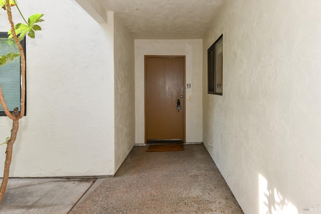 entrance to property featuring stucco siding