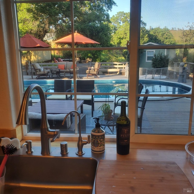 view of swimming pool featuring a sink