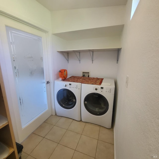 laundry room featuring washing machine and dryer, laundry area, and light tile patterned floors