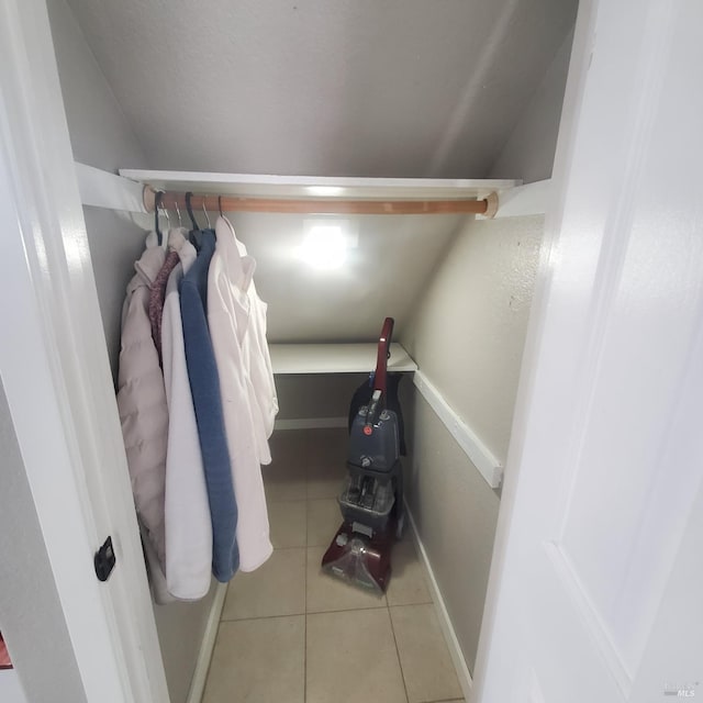 spacious closet featuring vaulted ceiling and tile patterned floors