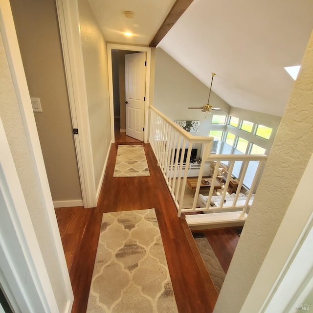 hallway featuring baseboards, wood finished floors, and stairs