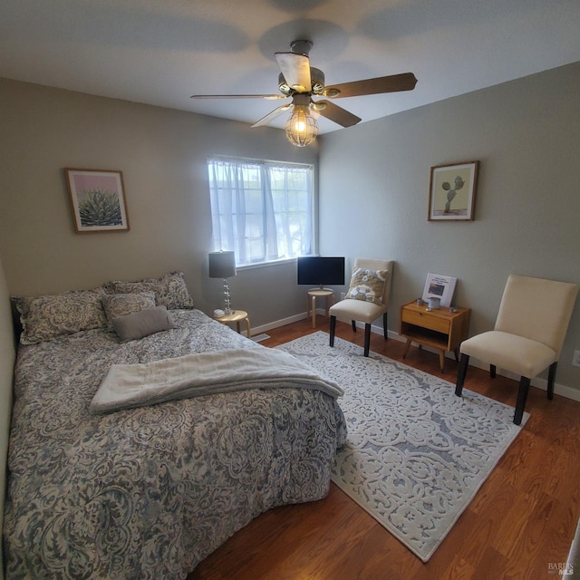 bedroom with baseboards, a ceiling fan, and wood finished floors