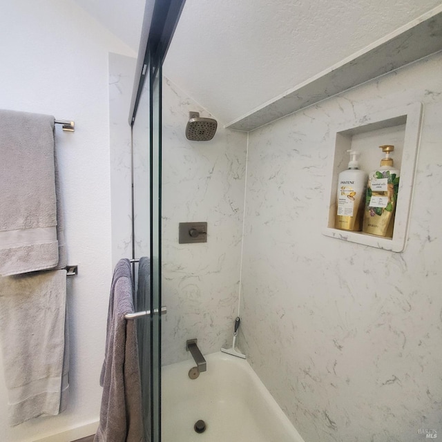 bathroom featuring vaulted ceiling and bathing tub / shower combination