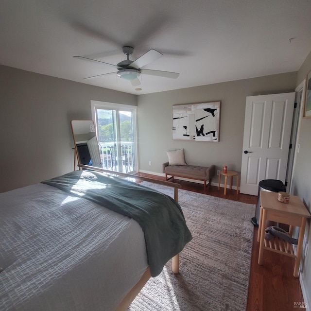 bedroom with wood finished floors, ceiling fan, baseboards, and access to exterior