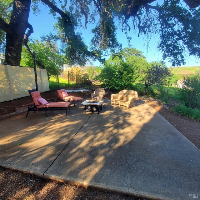 view of patio / terrace featuring an outdoor fire pit