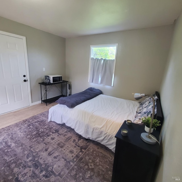 bedroom with wood finished floors
