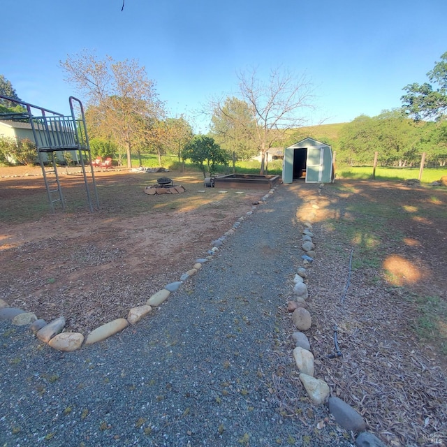 view of yard featuring a shed and an outdoor structure