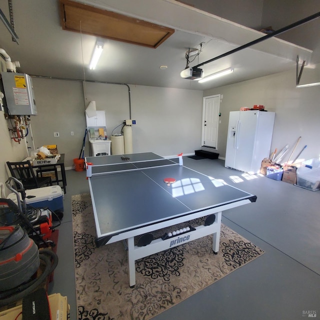 game room featuring a garage, attic access, finished concrete floors, and washer / clothes dryer