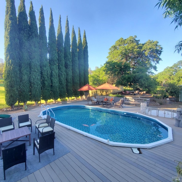 outdoor pool with a wooden deck