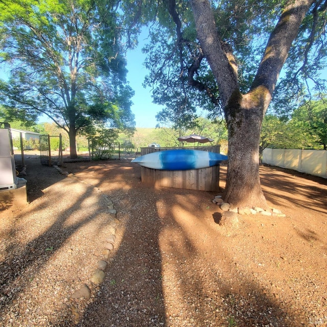 view of yard with an outdoor pool and fence