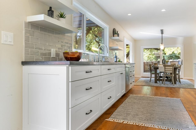 kitchen with white cabinets, dark wood-style floors, backsplash, and open shelves