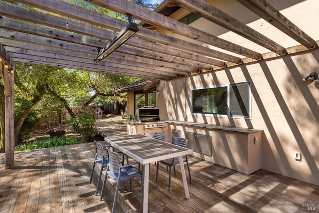 deck featuring grilling area, outdoor dining space, exterior kitchen, and a pergola