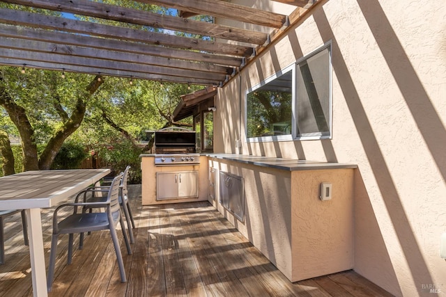 deck featuring exterior kitchen, a pergola, a grill, and outdoor dining area