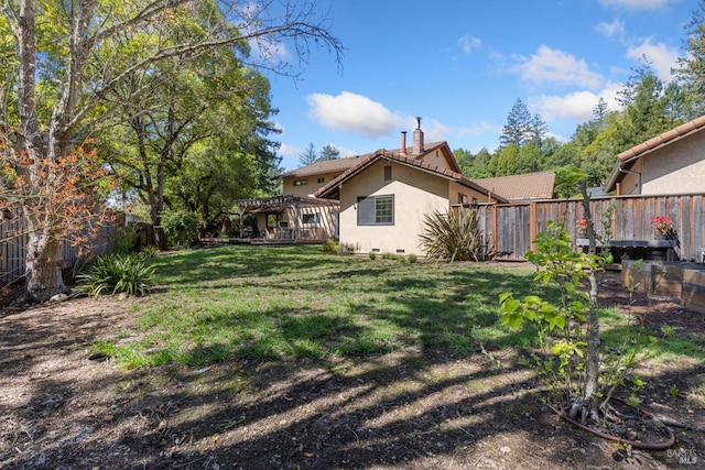 view of yard with a pergola and a fenced backyard