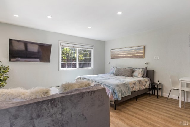 bedroom with baseboards, light wood finished floors, and recessed lighting
