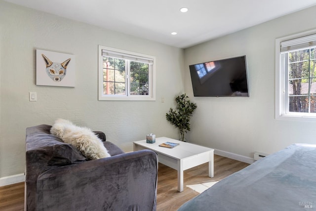 living room with baseboards, recessed lighting, a baseboard heating unit, and wood finished floors