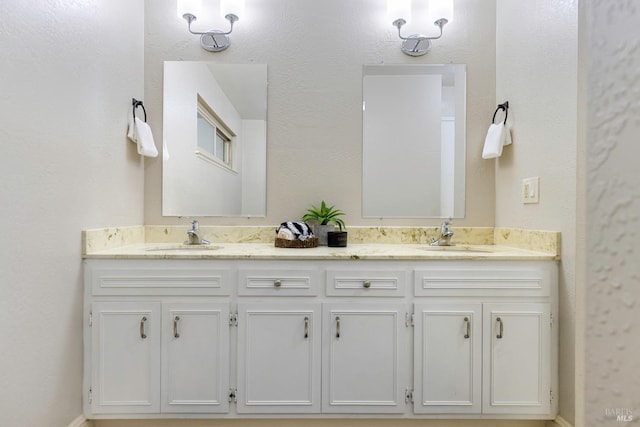 bathroom featuring double vanity and a sink