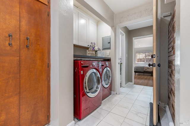 laundry area with washer and dryer, electric panel, baseboards, and cabinet space